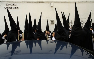 Penitents wait before taking part in the procession of "Santa Genoveva" brotherhood during Holy Week in the Andalusian capital of Seville