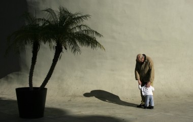 An elderly man conforts a baby in the Andalusian capital of Seville