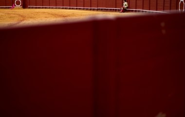 Spanish matador Cayetano sits on the barrier during a bullfight in Seville