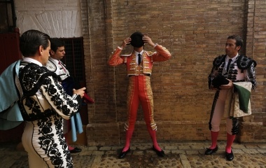 French matador Castella puts his montera between assistants before getting into the arena to bullfight in Seville