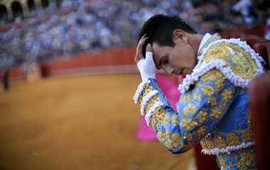 Spanish matador Manzanares touches his head during a bullfight in the Andalusian capital of Seville