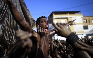 A reveller covered in grease shouts as he takes part in the annual "Cascamorras" festival in Baza