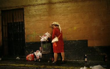 A man dressed up as a woman urinates during the carnival in Cadiz