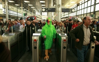 A man in fancy costume passes a ticket control gate at Cadiz train station during the Carnival of Cadiz