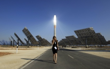 A woman walks at the new solar power plant "Gemasolar" the day of its inauguration in Fuentes de Andalucia