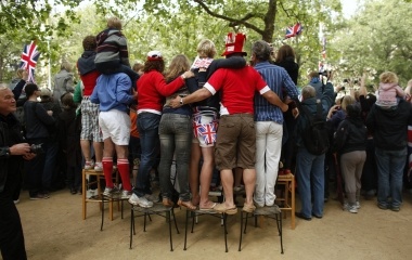 People stand on chairs in St James park after the marriage of Prince William's and Kate Middleton in Westminster Abbey, in central London