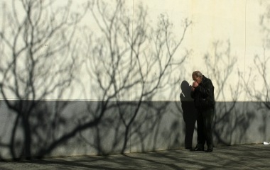 A man lights a cigarette butt after taking it from the ground in the Andalusian capital of Seville
