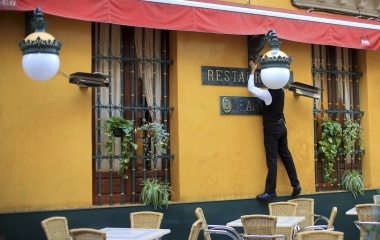 A waiter plugs in a heater on the facade of a restaurant in the Andalusian capital of Seville