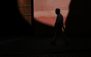A man walks in the Santa Cruz neighborhood of the Andalusian capital of Seville