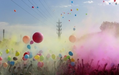 Participants throw coloured powders and release ballons as they take part the Color Run in the Andalusian capital of Seville