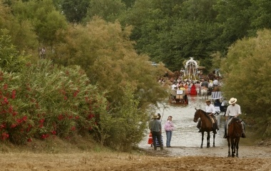 Pilgrims walk across the Quema River during a pilgrimage to the shrine of El Rocio in the province of Seville