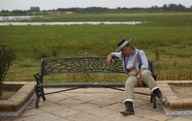 A pilgrim sleeps on a bench in the village of El Rocio in Almonte, southern Spain