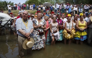 Pilgrims pray in Quema river on their way to the shrine of El Rocio in Aznalcazar, southern Spain