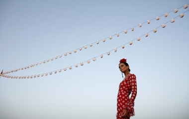 A model presents a flamenca creation from Lina during a Flamenco Fashion Show in Seville
