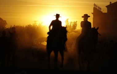 Pilgrims ride horses next to the shrine of El Rocio in the province of Huelva