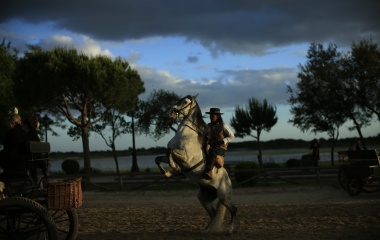 A pilgrim rides next to the shrine of El Rocio in Almonte, southern Spain
