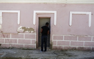 Howard Jackson, 36, a Liberian migrant closes the lock of the doorway of his home in the Andalusian capital of Seville, southern Spain
