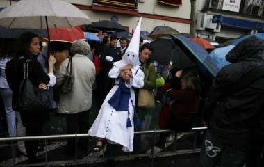 A woman holds a penitent during Holy Week in the Andalusian capital of Seville