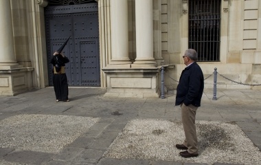 A penitent of "Los Estudiantes" (The Students) brotherhood adjusts his hood during Holy Week in Seville