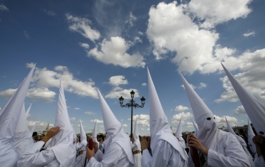 Penitents take part in the procession of 'San Gonzalo' brotherhood during Holy Week in the Andalusian capital of Seville
