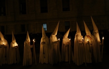 Penitents of La Paz (The Peace) brotherhood make their penance during a Holy Week procession in the Andalusian capital of Seville, southern Spain