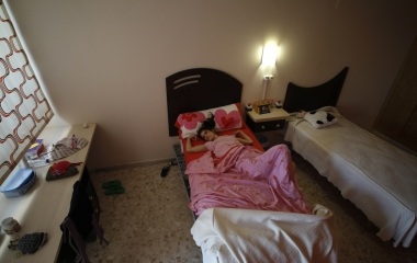 Deaf-blind Ines Garcia sleeps on a bed at her bedroom in Santa Angela de la Cruz centre in Salteras