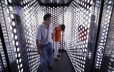 Deaf-blind Ines Garcia is pulled by her father, Juan Carlos Garcia, in a elevator of Metropol Parasol, a wooden architectural structure in Seville