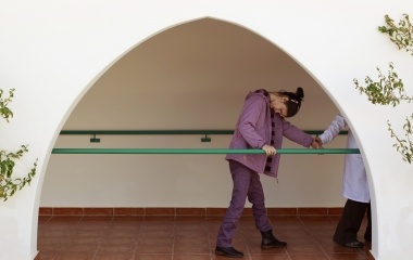 Deaf-blind Ines, 22, follows Carola, an assistant, in Santa Angela de la Cruz centre in Salteras, near Seville