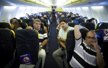 Jose Manuel Abel, 46, sits during a flight to Barcelona on his way to Munich in Seville