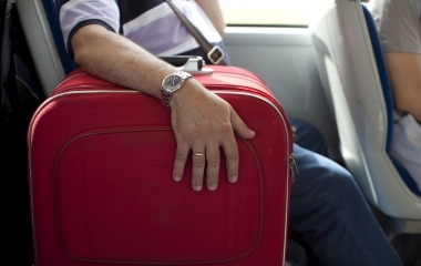 Jose Manuel Abel, 46, holds his suitcase before catching a flight to Munich at El Prat airport in Barcelona