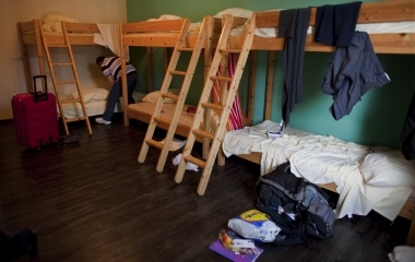 Jose Manuel Abel, 46, makes the bed in a hostel during his first day in Munich
