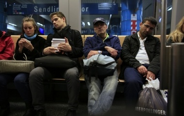 Jose Manuel Abel (2nd R), 47, sits on a subway car on his way to work in Munich