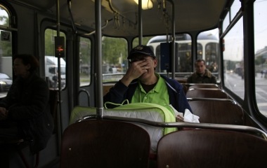 Jose Manuel Abel, 47, touches his face on a tram carriage in Munich