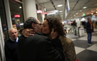 Jose Manuel Abel, 47, and his wife Oliva, 47, kiss themselves after she arrives from Spain in the airport of Munich