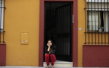 Japanese learner of flamenco song and dance, Maika Kubo, 24, sits at the doorway of the building where she lives in the Triana city quarter in Seville