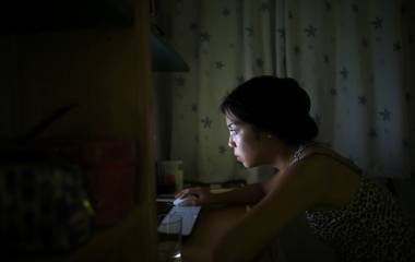 Japanese learner of flamenco song and dance, Maika Kubo, 24, surfs the internet in her bedroom in the Andalusian capital of Seville