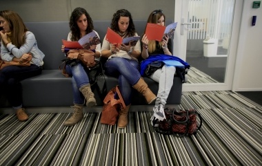 Spanish nurses Maria Jose Marin, her twin sister Maria Teresa and Maria Grifo read a brochure in the immigration office in the Hague
