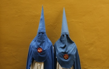 Penitents of San Esteban brotherhood pose during Holy Week in the Andalusian capital of Seville, southern Spain