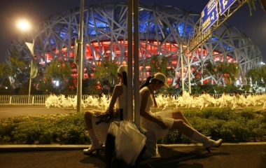 Performers wait before taking part in the last rehearsal of the opening ceremony of the Beijing 2008 Olympic Games
