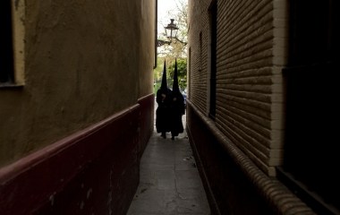 Penitents of "Santa Cruz" (Saint Cross) brotherhood walk to their churchduring Holy Week in Seville