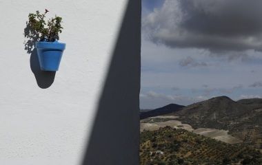A flower pot is on the wall in the white village of Olvera, southern Spain