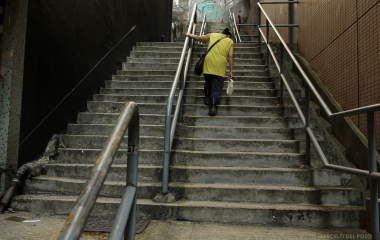 A worker woman climbs stairs in the Central district in Hong Kong