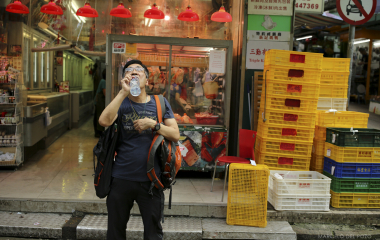 A man drinks in the Soho district in Hong Kong
