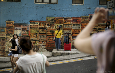 People pose for pictures in the Soho district in Hong Kong