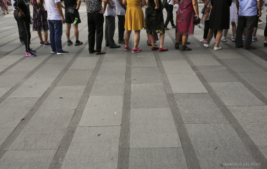 People stand in the Wong Tai Sin district in Hong Kong