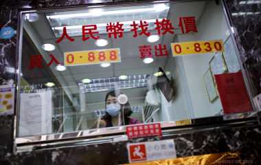 A worker looks on in a currency exchange office in the Central district in Hong Kong