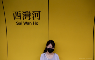 A woman poses for a picture in the Sai Wan Ho subway station in Hong Kong