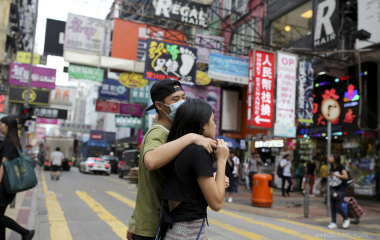 A couple walk in the Mong Kok district in Hong Kong