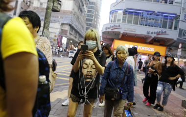 A woman uses a mobile phone in the Mong Kok district in Hong Kong