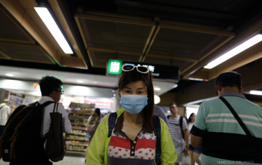 A woman looks on in an Island line subway station in Hong Kong